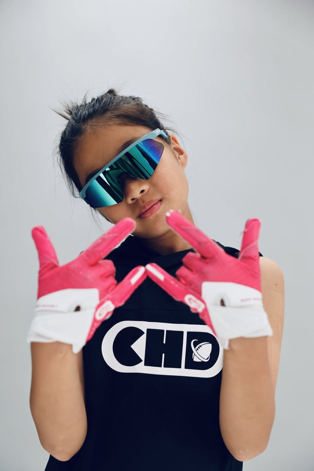 Dark sleeveless CHD top with white front logo, worn with bright gloves