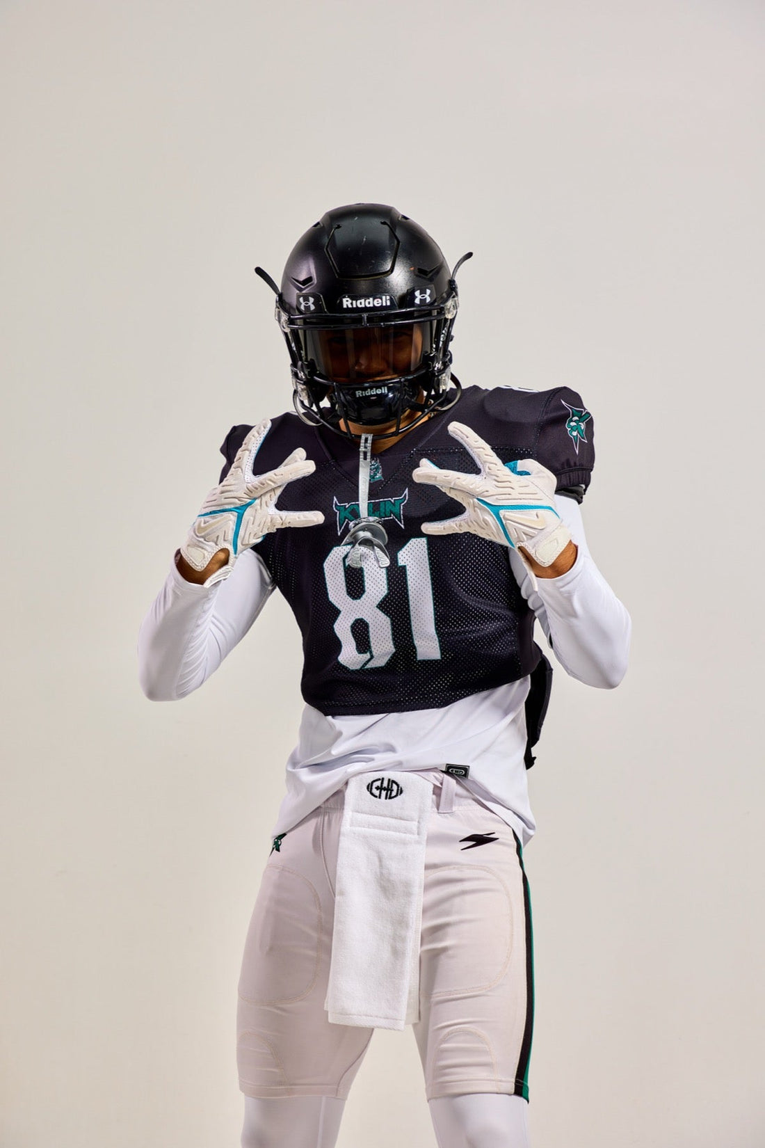 Front detail of a dark mesh football practice jersey with white number 81 and teal graphics