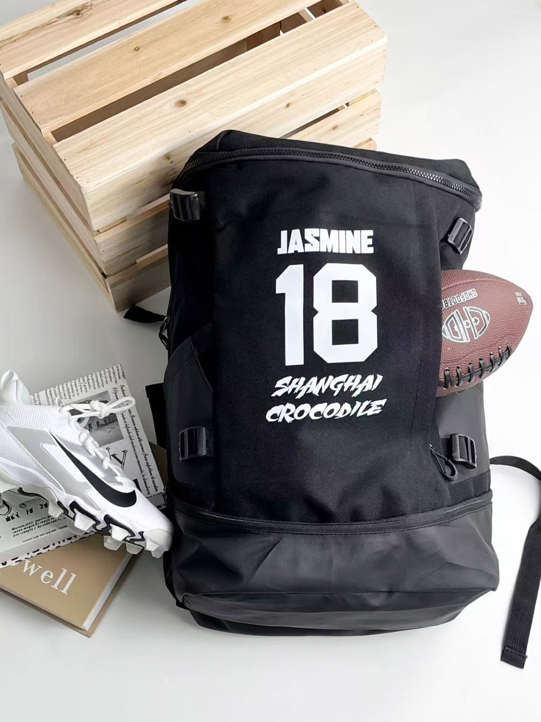 Black football backpack with JASMINE lettering and a large white number 18