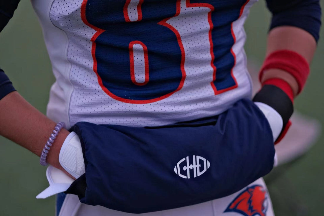 Blue CHD football hand warmer worn at the waist with hands entering from both sides