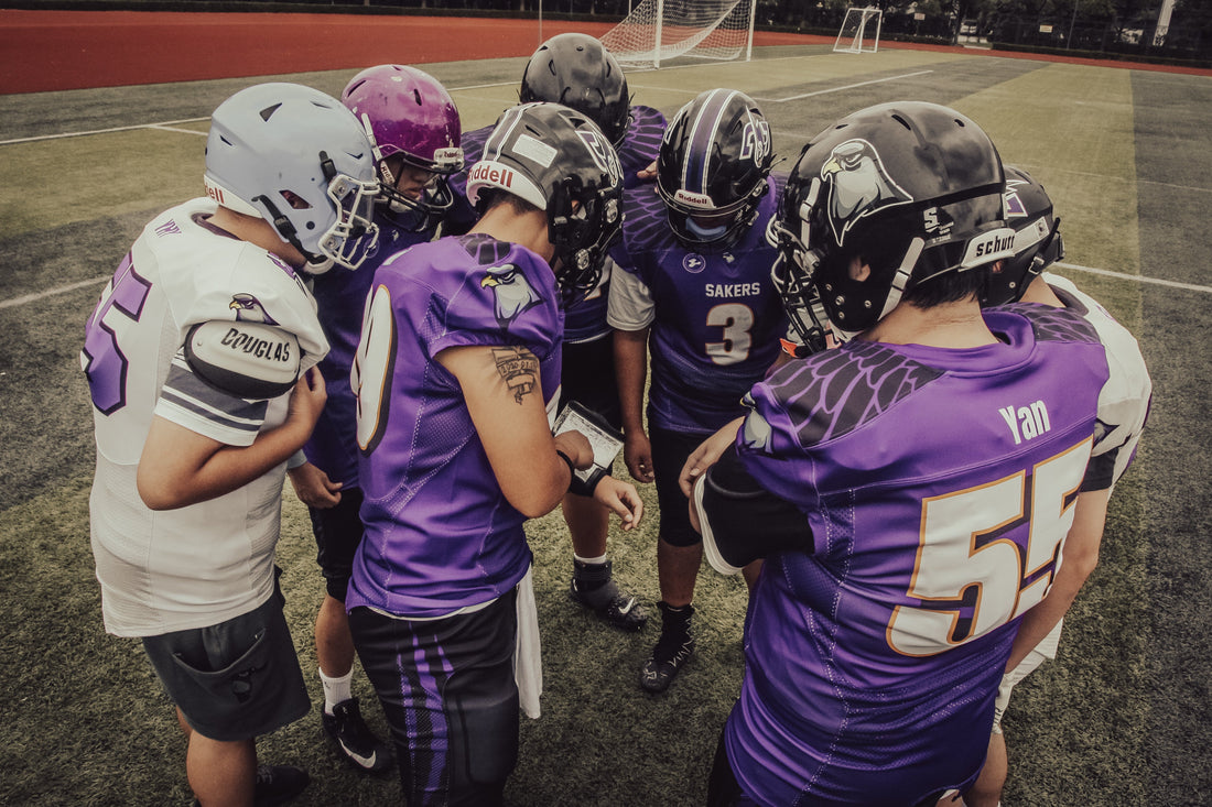 Shanghai Engineering University Falcons players gathered on the field in purple T101 football jerseys