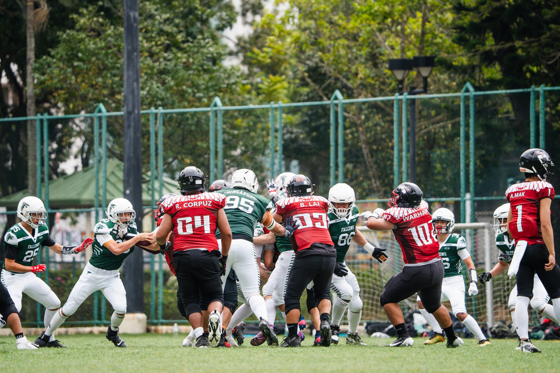 SingaporeFALCONS players wearing green and white T104 football jerseys on the field