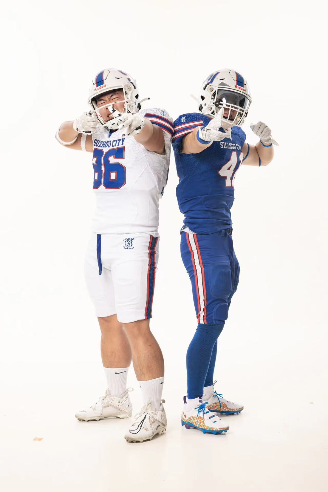 Two Suzhou Blue Knights players in blue and white T101 football jerseys with SUZHOU CITY lettering