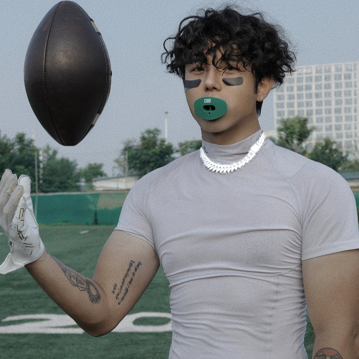 Real CHD mouthguard player photo — square composition — chd air 2 0 green football mouthguard