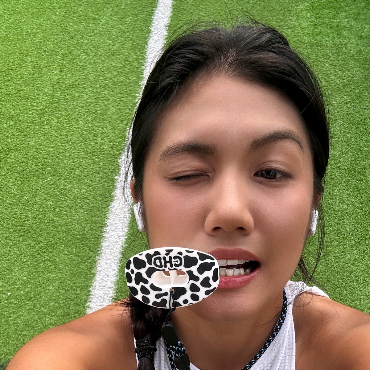 Real CHD mouthguard player photo — square composition — chd cow print design football mouthguard