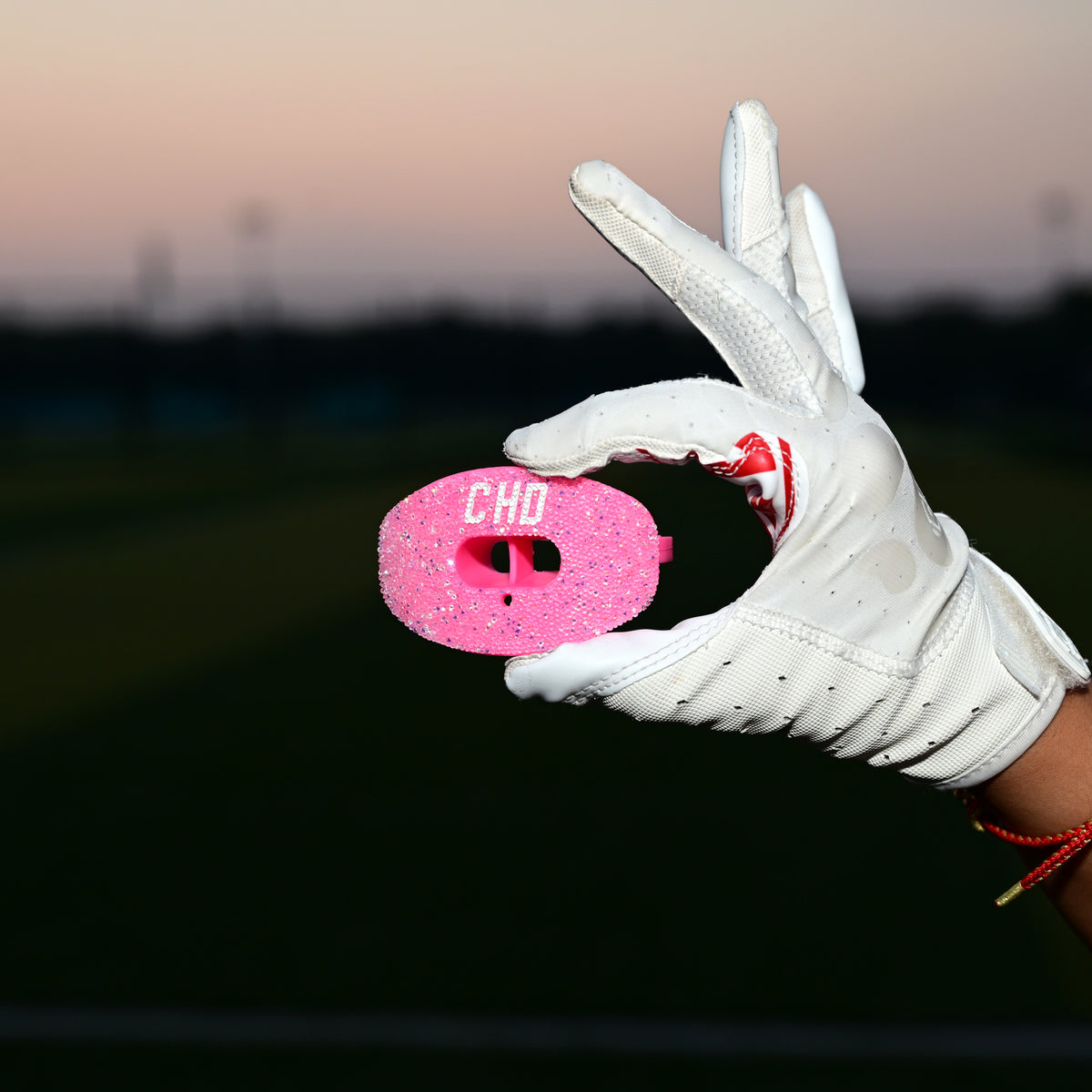 Real CHD mouthguard player photo — square composition — chd diamond pink on pink football mouthguard